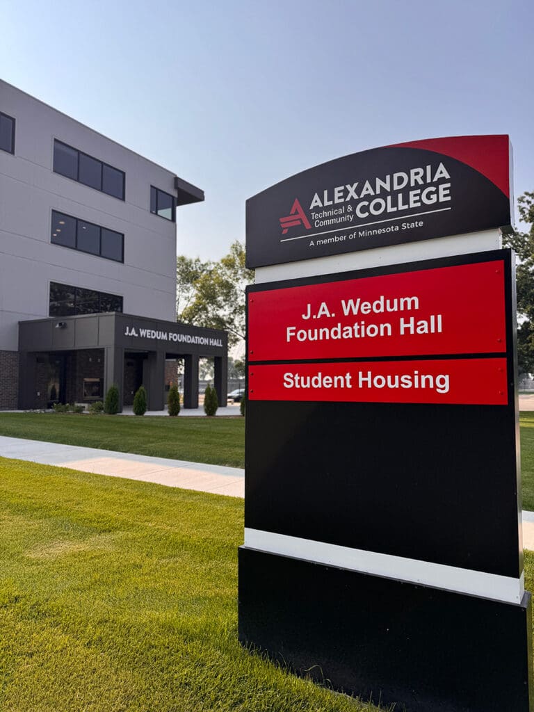 A sign for ATCC stands before the modern ATCC Foundation Hall, featuring prominent labels for “ATCC Foundation Hall” and “student housing,” while the building’s large windows offer a contemporary touch.